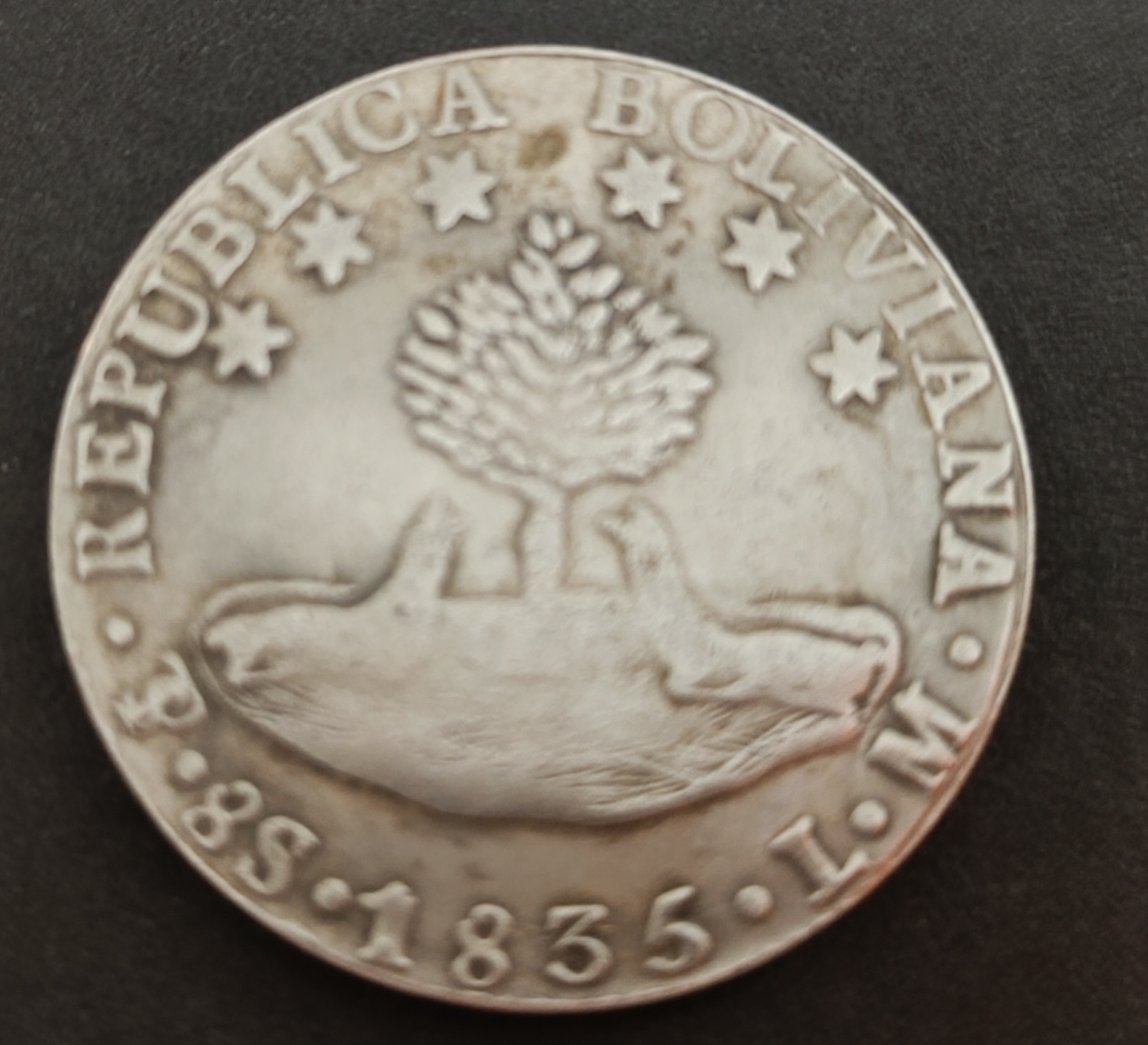 This coin is very old and rare for the state of Bolivia.